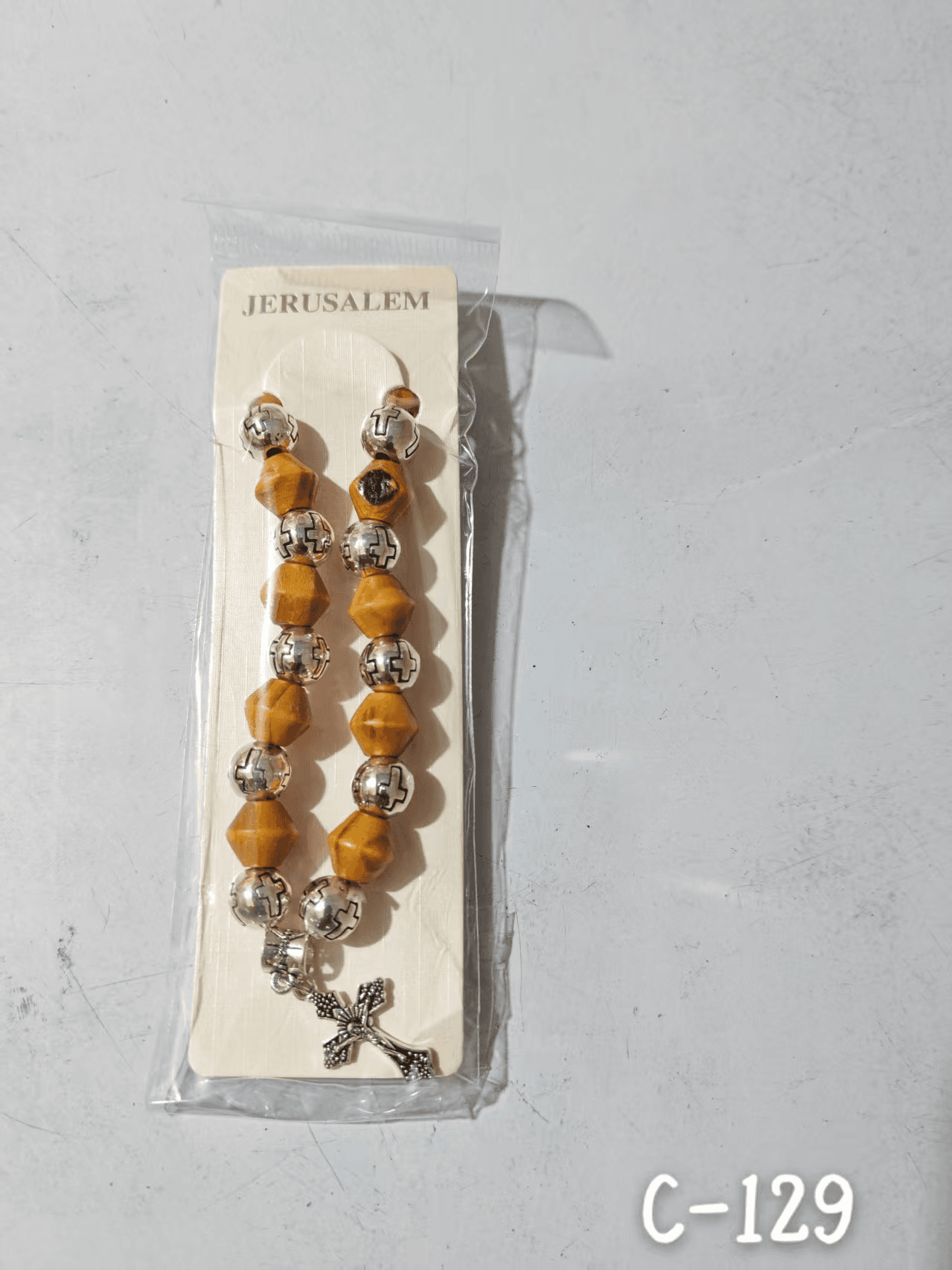 Elastic Cross Bead Bracelet with angular bead details and cross accent
